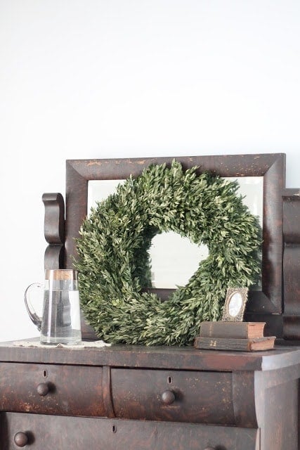 A wreath resting on a side table.