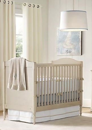 A nursery with a large window and a crib