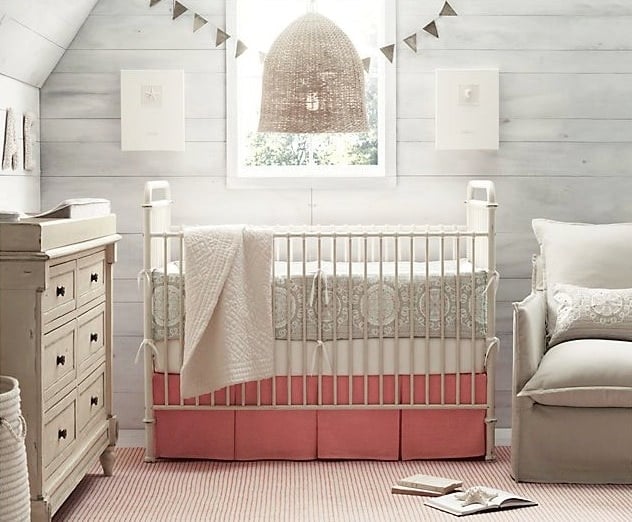 A nursery with a large window and a crib