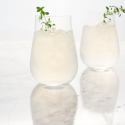 Two lemonade vodka cocktails garnished with fresh thyme