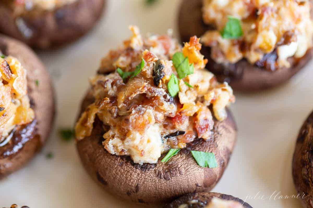 Bacon stuffed mushrooms on a white surface.