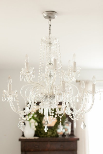 A chandelier over a dining room table