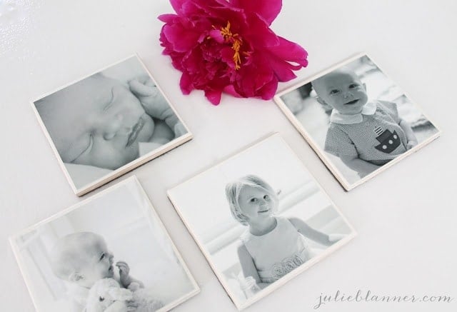 A close up of a flower next to photo coasters.