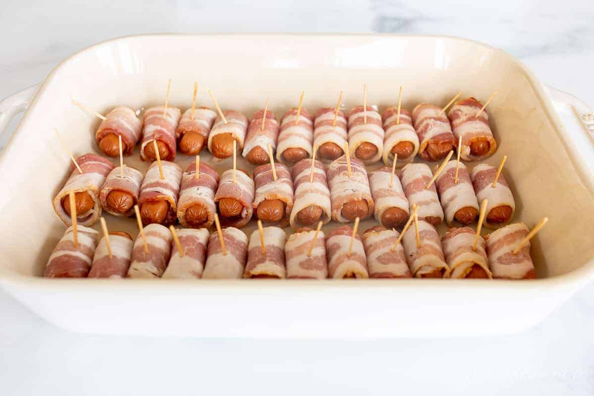 cocktail wieners wrapped in bacon in baking dish