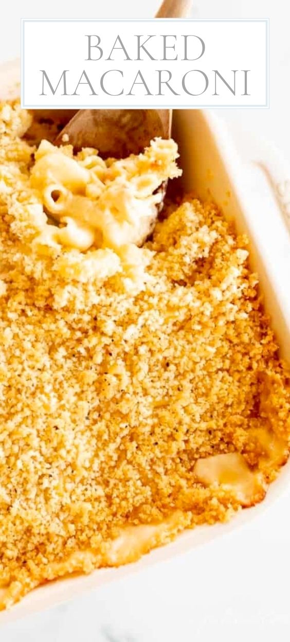 On a marble counter, there is a white baking dished of baked macaroni.