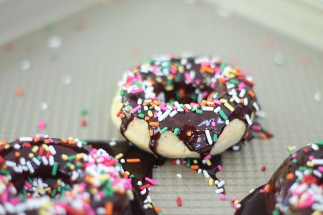 A baked doughnut with icing and sprinkles
