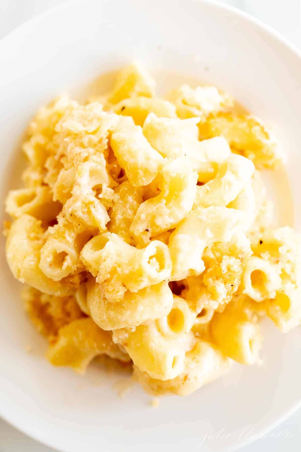 A serving of baked macaroni and cheese on white plate
