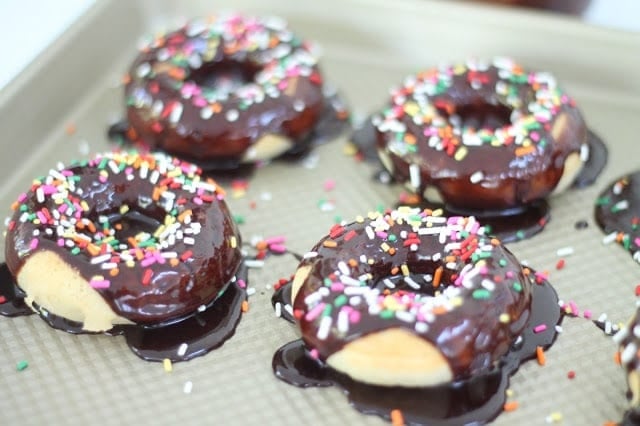 Iced doughnuts on a baking sheet ready to serve