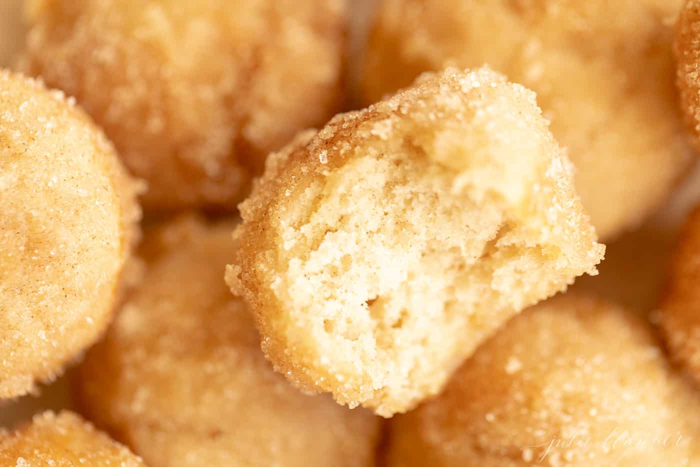 close up bite out of a miniature cinnamon sugar muffin