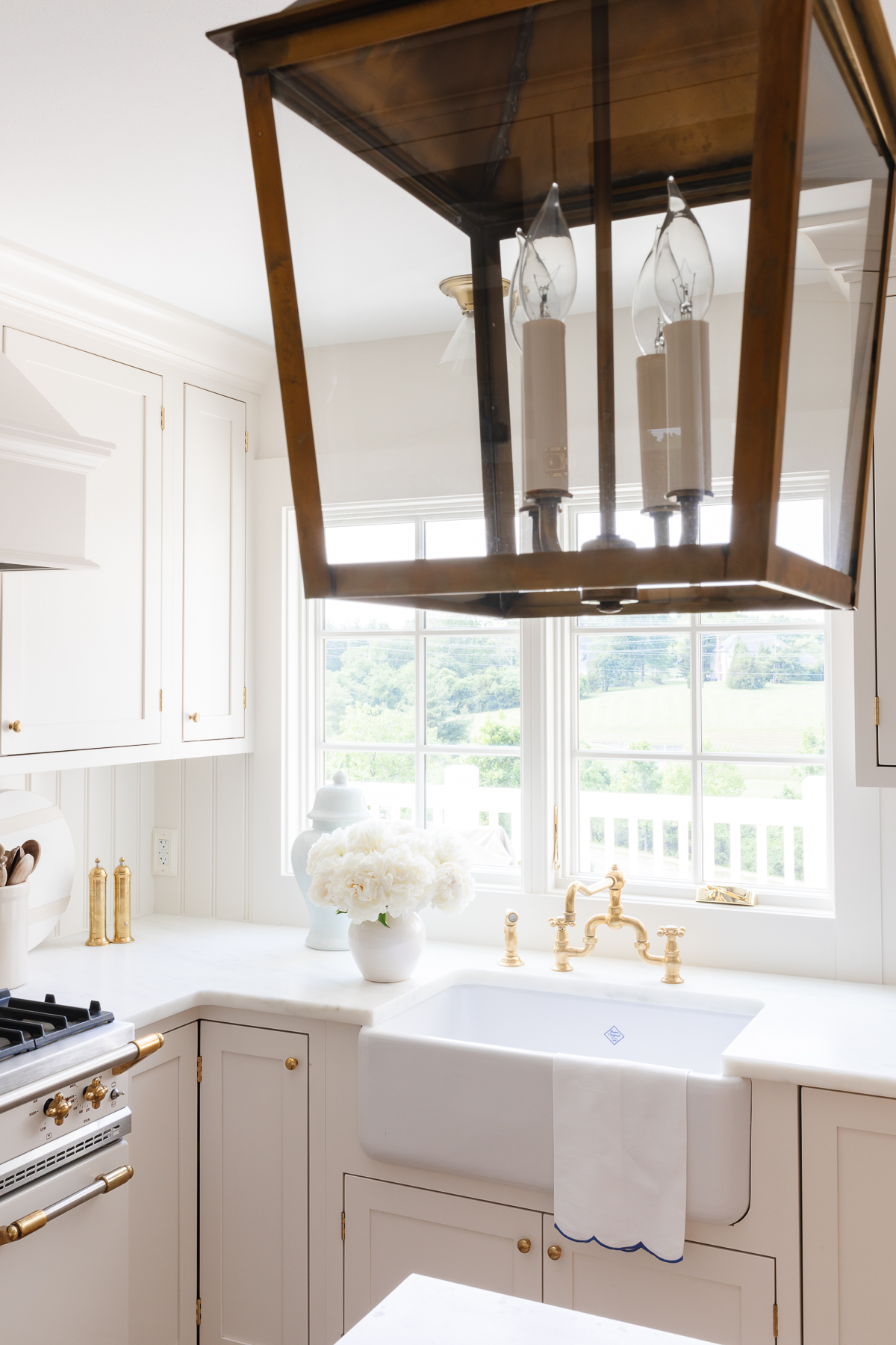 A white kitchen with white quartz countertops in a guide to carrara marble countertop alternatives.