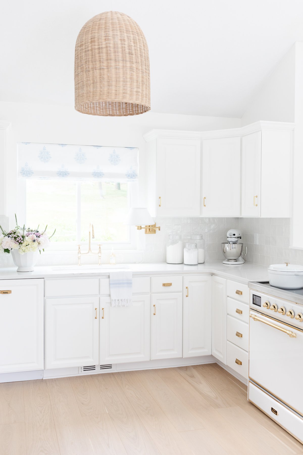 A white kitchen with white quartz countertops in a guide to carrara marble countertop alternatives.