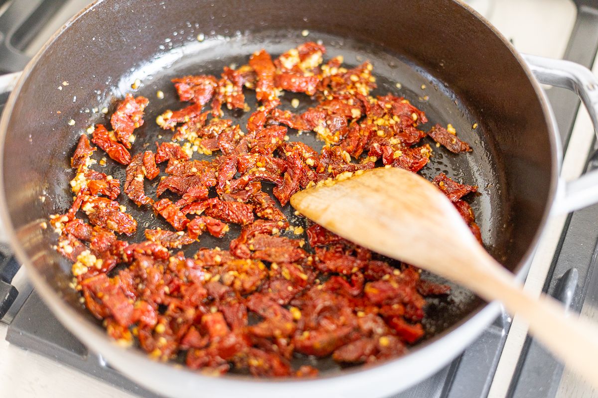 Sun dried tomatoes in a pan on stovetop.