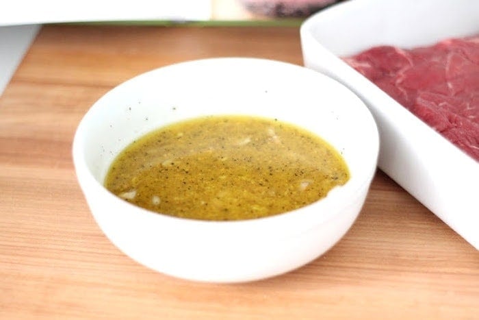 The steak marinade in a white bowl