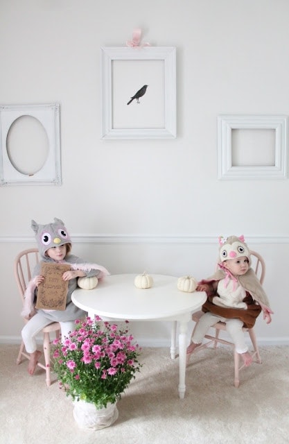 Two girls dressed up sitting at a table