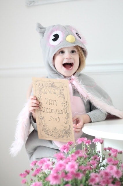 A little girl sitting on a chair in a costume