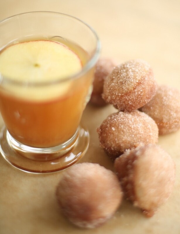 apple cider donut holes with apple cider in a glass