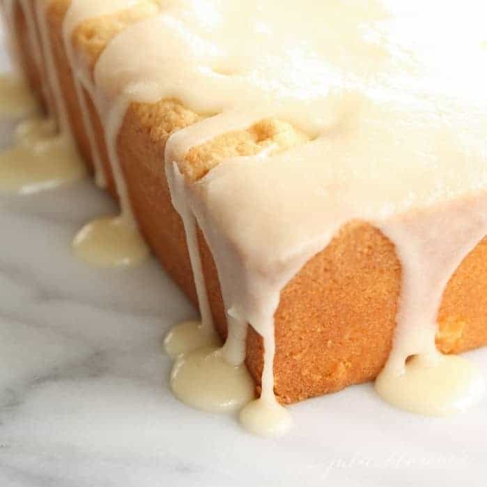 A pound cake on a marble surface, covered in a cake glaze.
