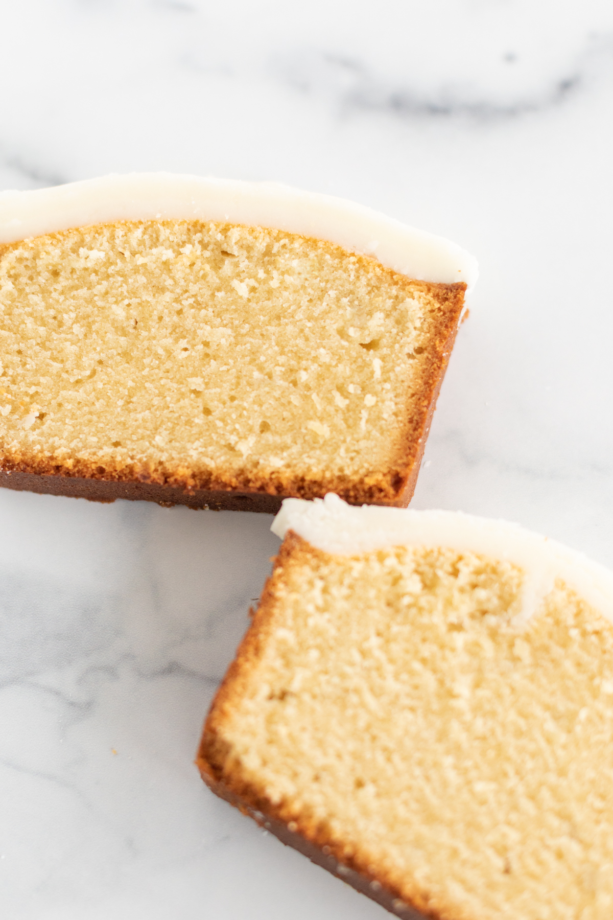 Two slices of pound cake covered in an easy pound cake glaze recipe. 