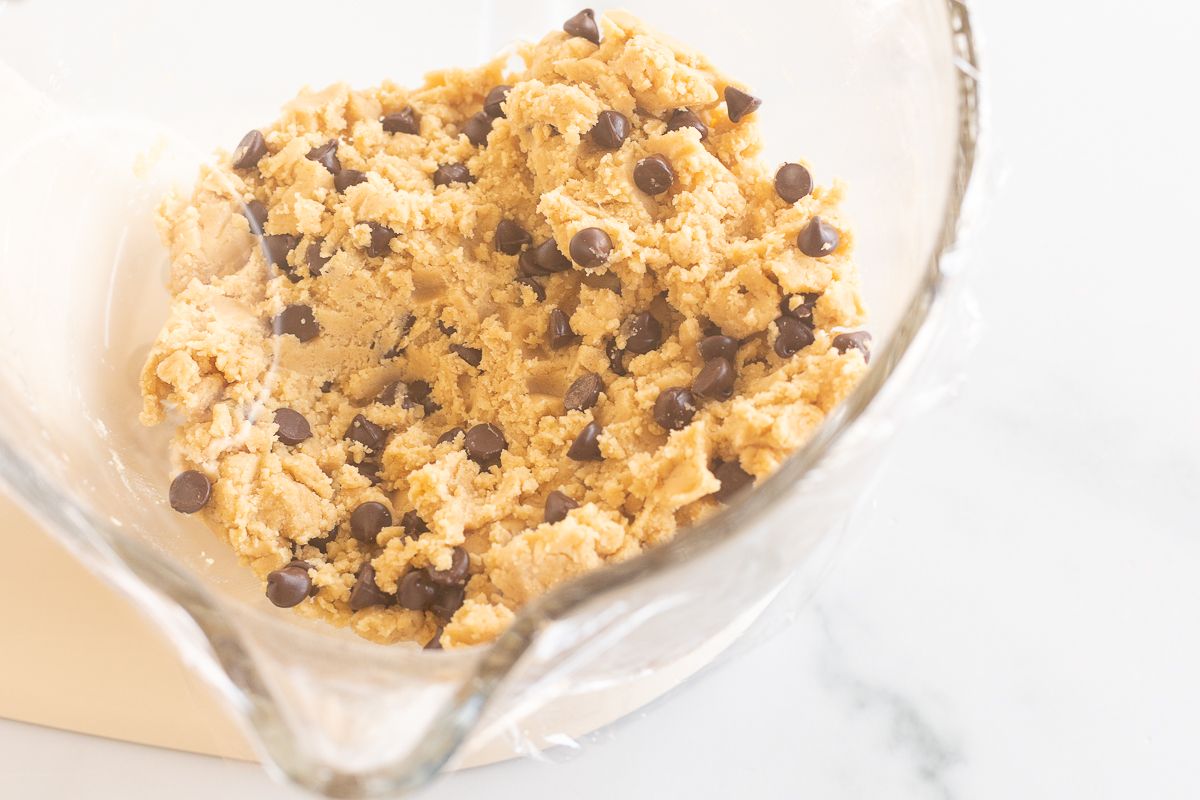 Cookie dough ingredients in a glass stand mixer.
