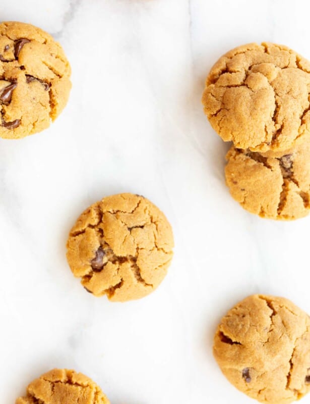 flourless peanut butter chocolate chip cookies scattered on marble counter