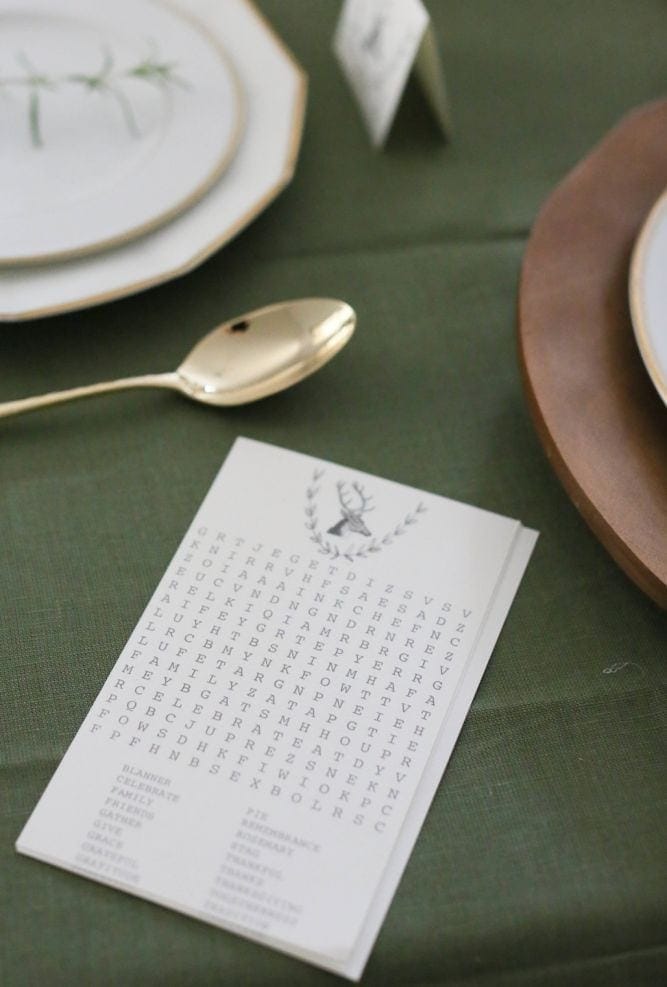Thanksgiving word search printed and placed on a Thanksgiving table setting.
