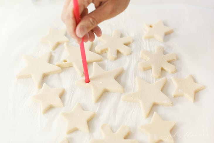 poking hole with a straw into salt dough ornaments