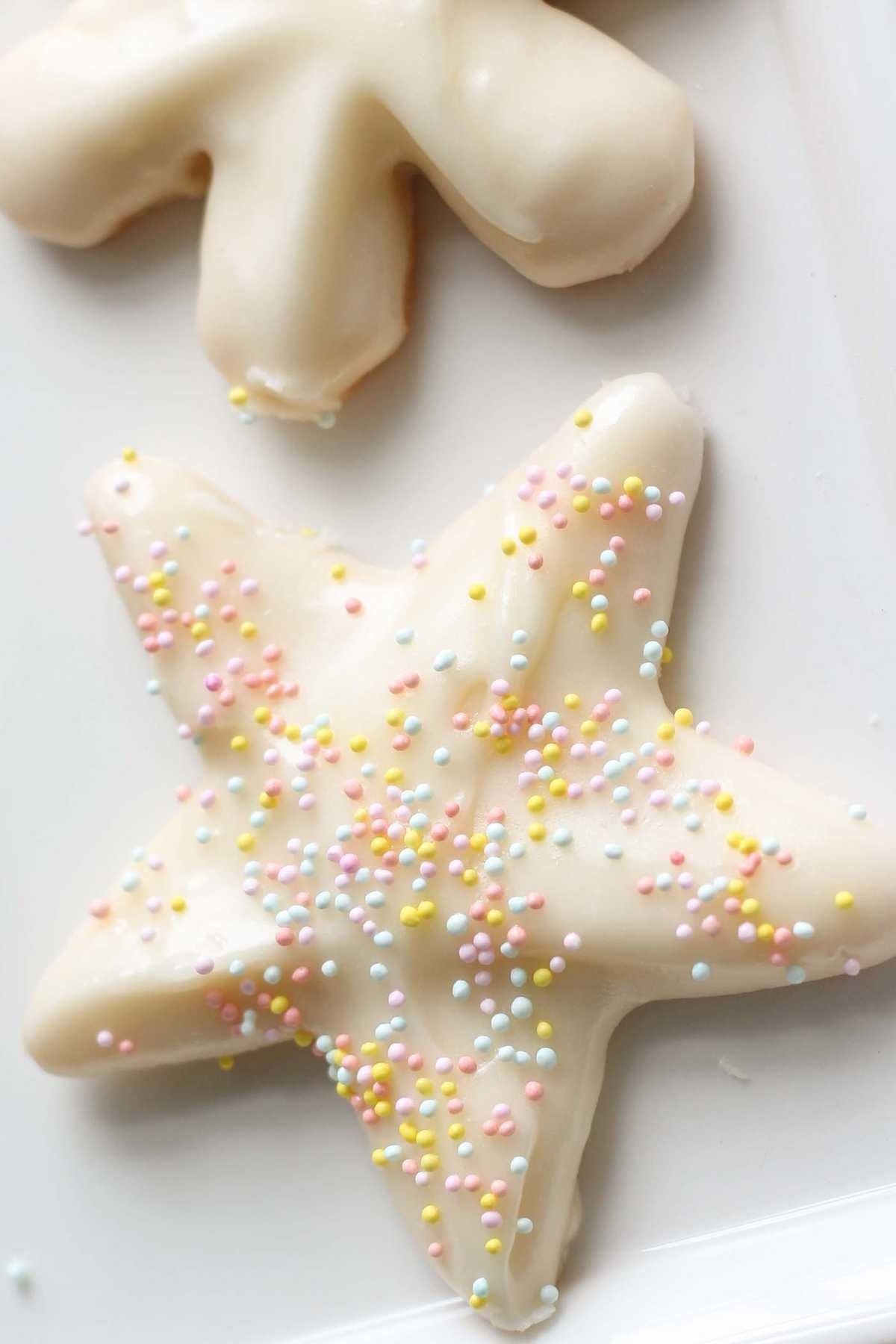 Star and snowflake sugar Cookies frosted with white buttercream sugar cookie icing.