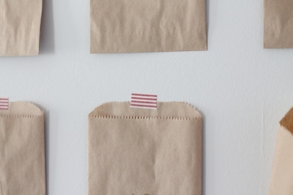 Kraft bag advent calendar stuck to the wall with fabric tape