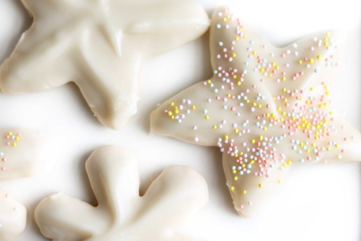 Star and snowflake shaped sugar cookies topped with sugar cookie icing. 