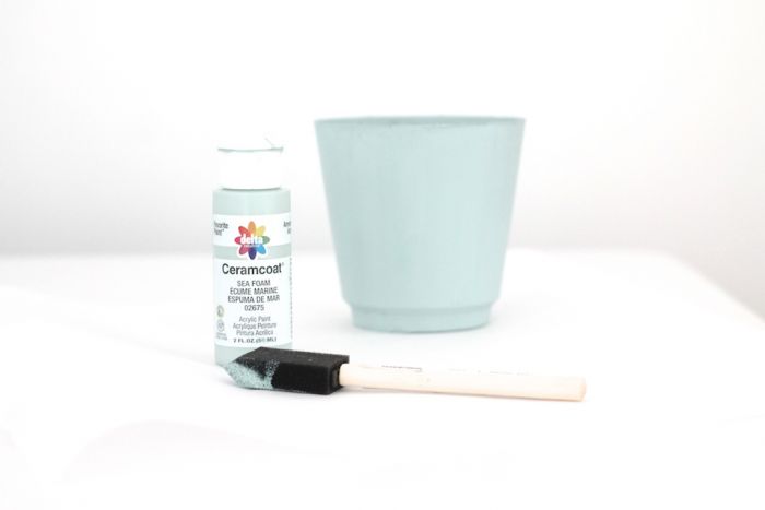 blue paint, paint brush and planter