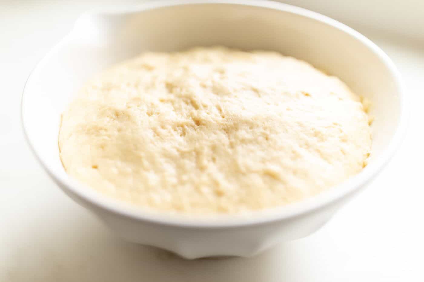 Belgian waffle dough in a white bowl. 
