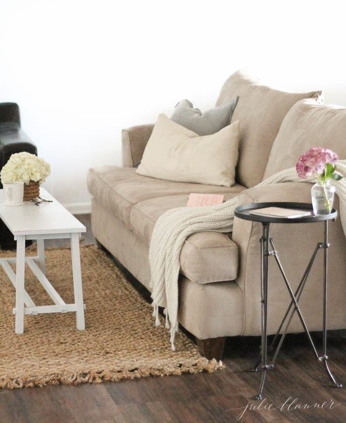 basement with sofa table and peel and stick tile