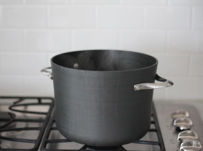 black pot of boiling water on gas stovetop