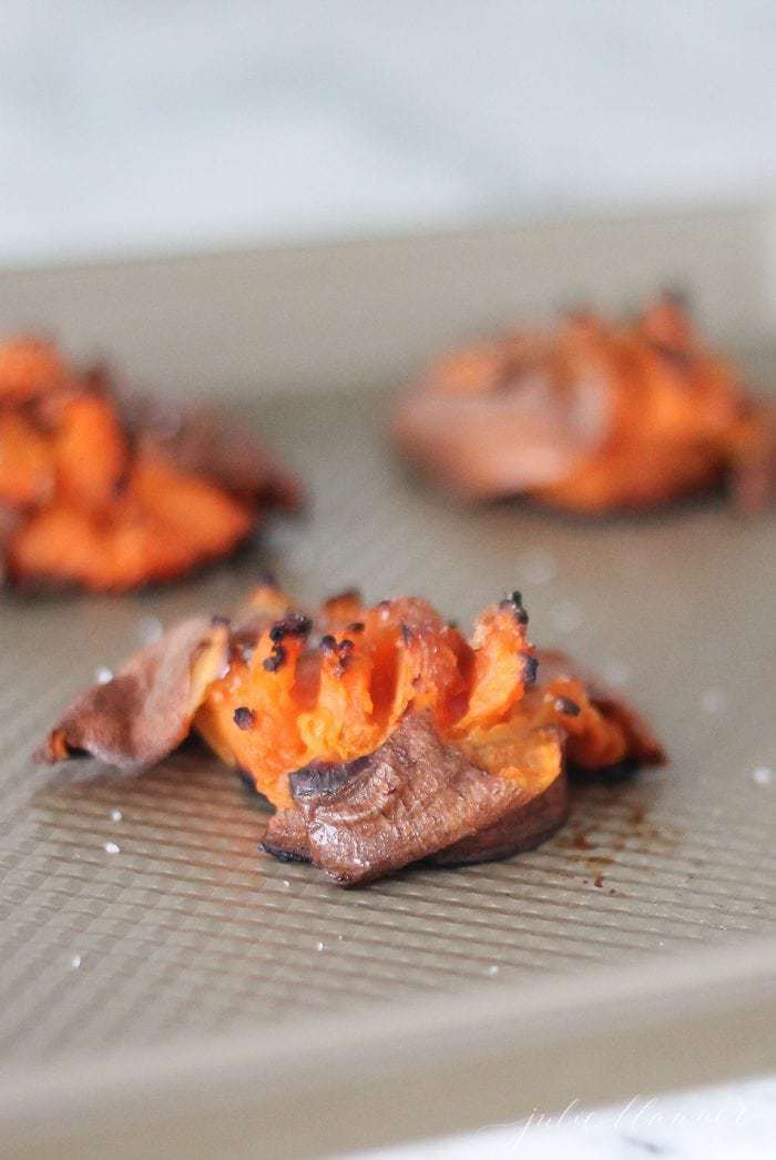 roasted smashed sweet potatoes on baking sheet