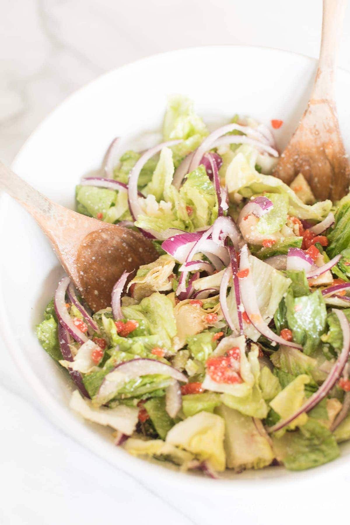 an italian salad in a white bowl