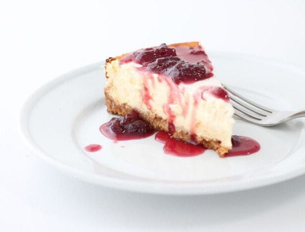 Strawberry cheesecake on a white plate.