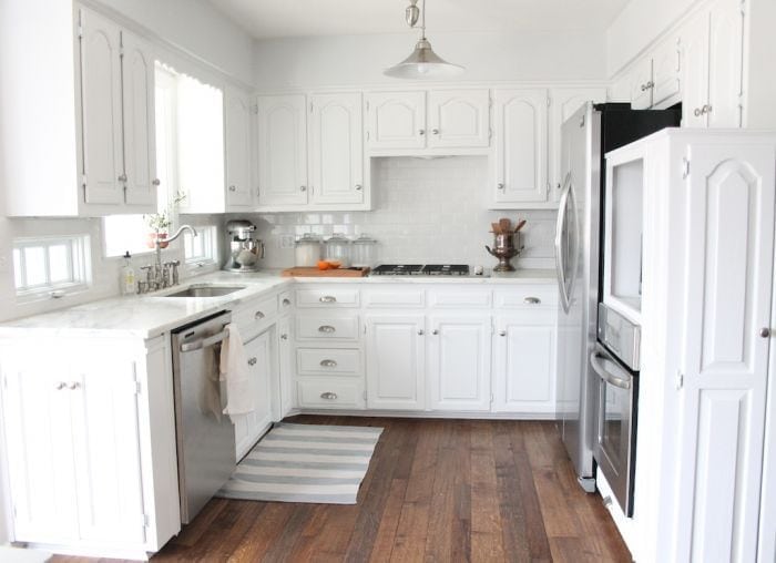 A white budget kitchen renovation with a wood floor
