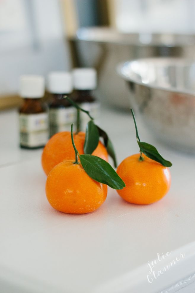 A sugar scrub bar set up with three little clementine oranges in the foreground. 