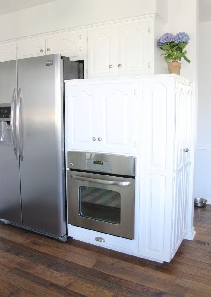 A white kitchen with a diy appliance garage