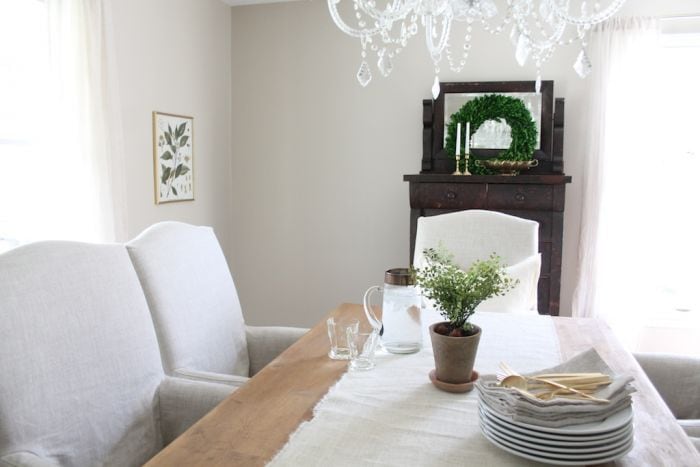 A dining room painted in a greige paint color, accessible beige