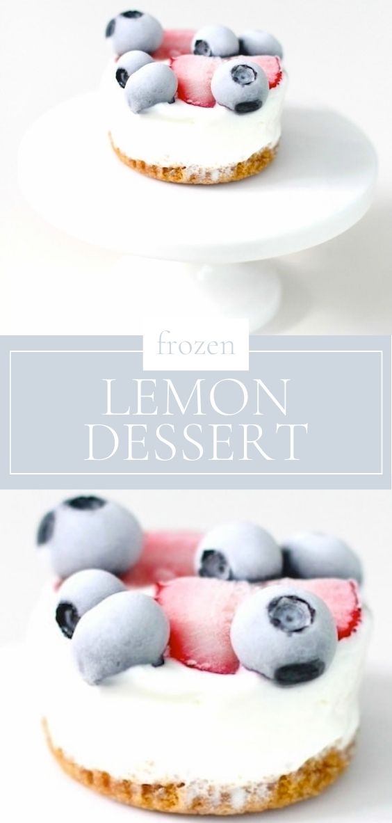 On a marble counter space, there is a white dessert stand holding a single frozen lemon dessert.