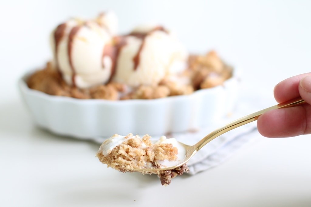 Peanut butter Cookie Cobbler in a creme brulee pan, topped with ice cream