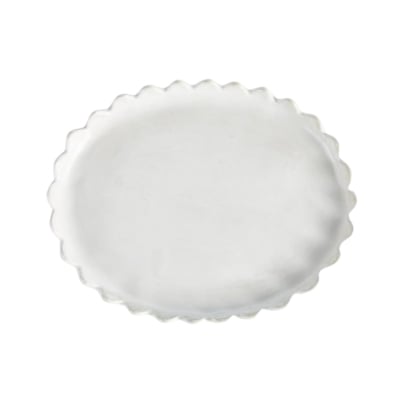 A white scalloped plate on a white background.