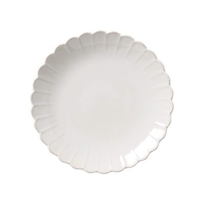 A white scalloped plate on a white background.