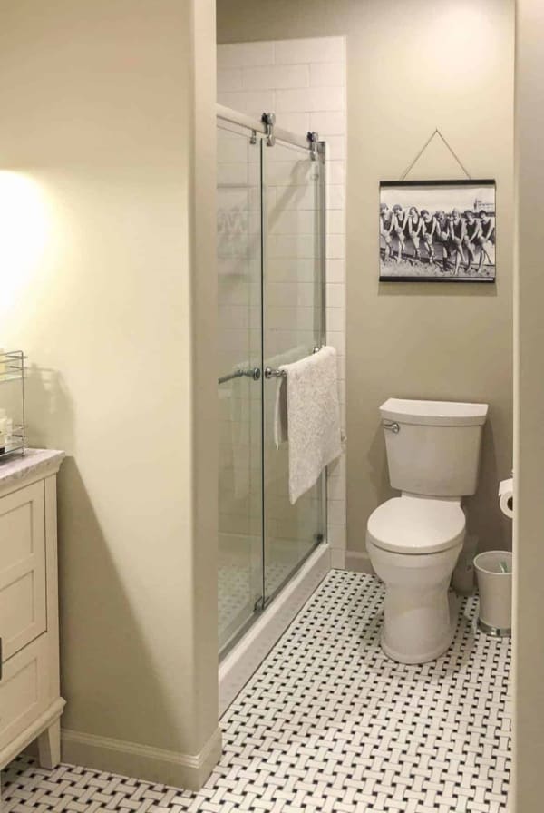 SW Accessible Beige in a small bathroom with a black and white vintage tile floor.