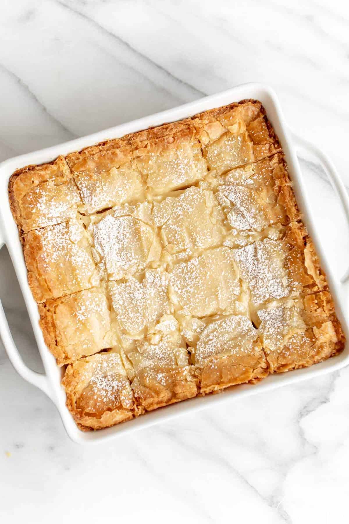 brown butter gooey butter cake garnished with powdered sugar