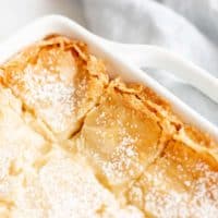 golden gooey butter cake with brown butter in white baking dish