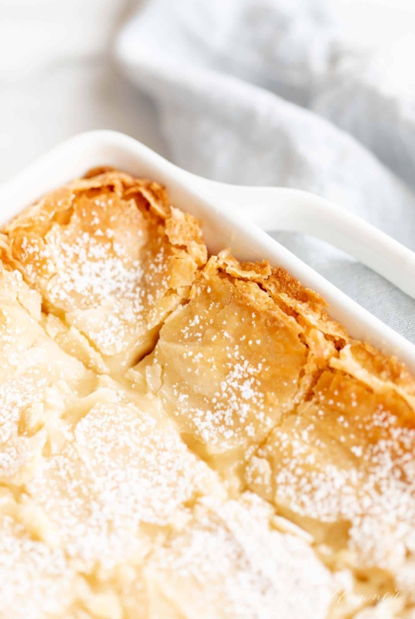 golden gooey butter cake with brown butter in white baking dish