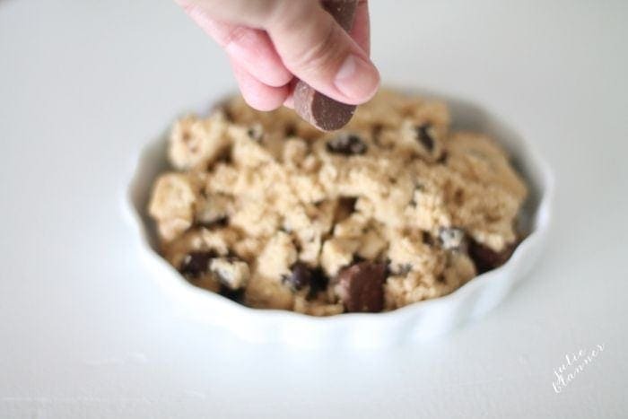 Salted caramel chocolate chip cobbler in a white dish.