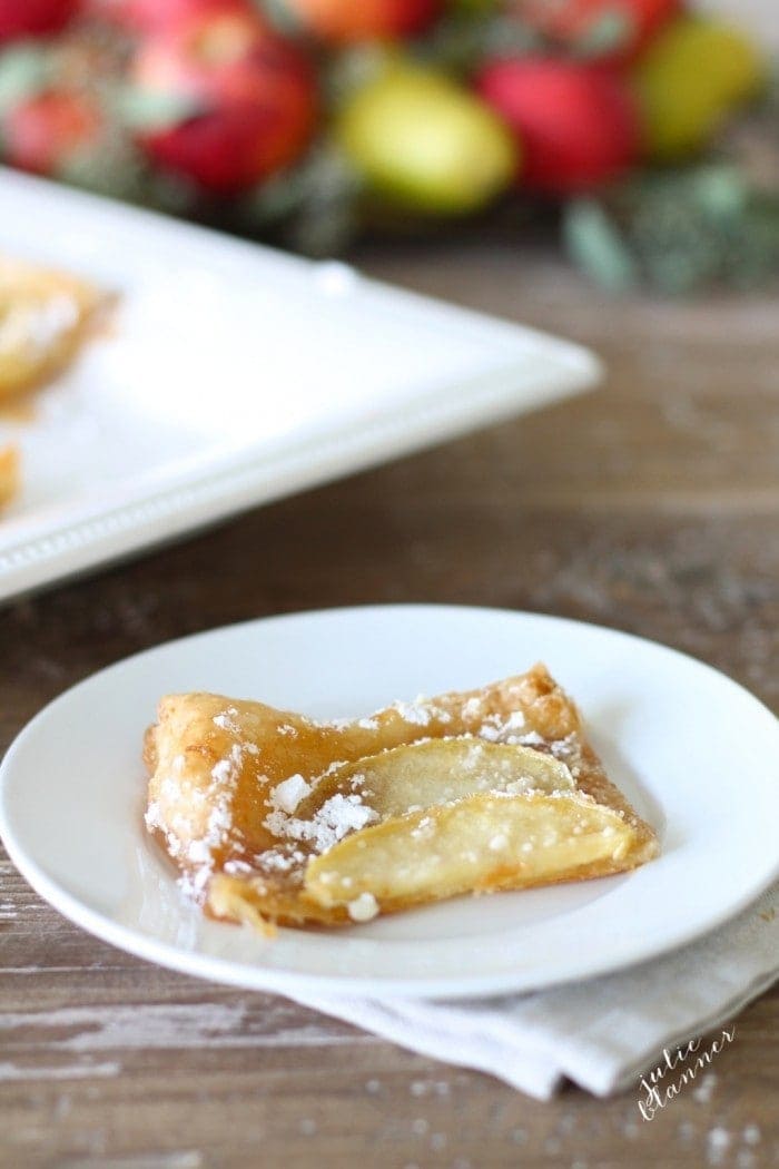 Close up of a piece of apple tart on a white plate